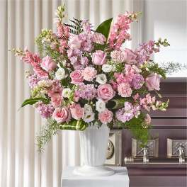 Pink and white floral arrangement in a white vase