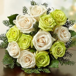 Bouquet of white and lime green roses with dark greenery
