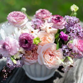 Pink and lavender bouquet in a white vase