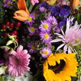 Colorful mixed bouquet with lilies, daisies, sunflowers, and hydrangeas
