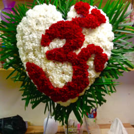 Heart-shaped red and white floral standing spray on an easel