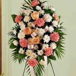 Standing floral spray with pink and white flowers on an easel