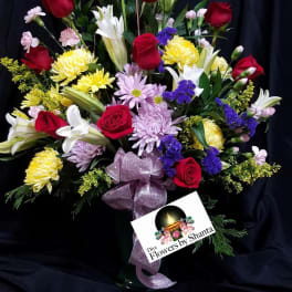 Bouquet of red roses, white lilies, and mixed blooms with a Mother's Day topper
