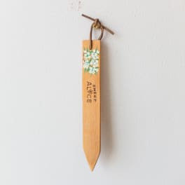 Wooden hanging marker with painted flowers and the words Sweet Alice