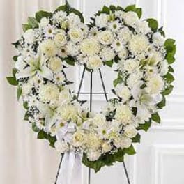 Heart-shaped white floral wreath on an easel