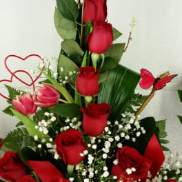 Tall bouquet of red roses with pink tulips and white baby's breath