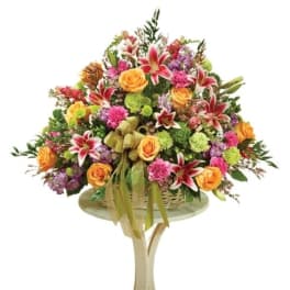 Large mixed bouquet with orange roses and red lilies on a stand