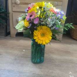 Colorful mixed bouquet in a blue glass vase