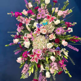 Large standing spray of pink, white, and purple flowers