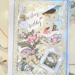 Decorative birthday card with floral illustrations and a bird