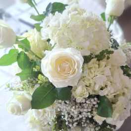 White rose and hydrangea bouquet with green foliage