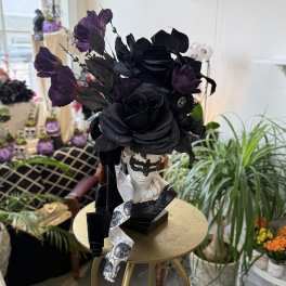 Black floral headpiece on a mannequin bust with purple accents