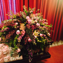 Large floral spray on a casket with pink and white flowers