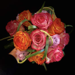 Bouquet of pink and orange roses with decorative grass loops
