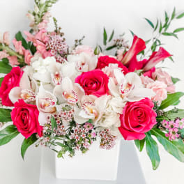 Pink and white floral arrangement in a white vase