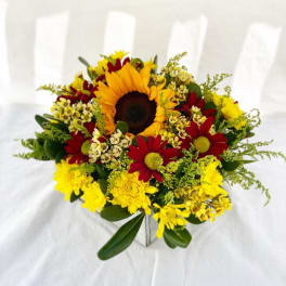 Sunflower and daisy bouquet in a square vase