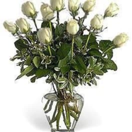 Arrangement of white roses in a clear glass vase
