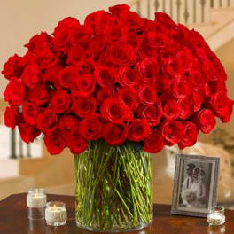 Large bouquet of red roses in a clear glass vase