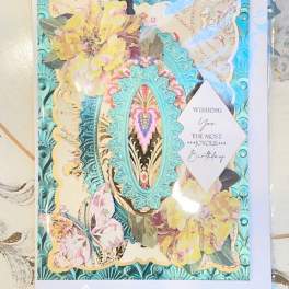 Decorative birthday card with pastel flowers and butterflies