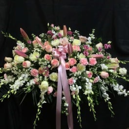 Large pink and white floral spray with a ribbon bow