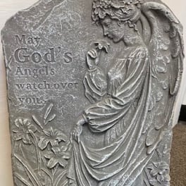 Gray stone plaque with an angel relief and engraved text