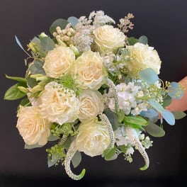 Cream rose bouquet with white filler flowers and eucalyptus