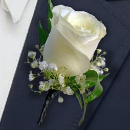 White rose boutonniere with baby's breath and green leaves