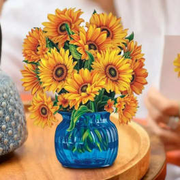 Sunflower bouquet in a blue vase on a table