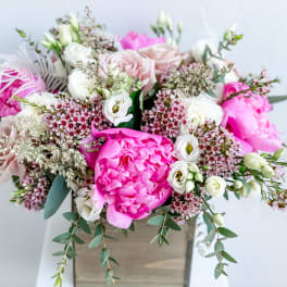 Pink and white mixed bouquet in a square vase