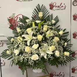 White rose and lily funeral wreath with black ribbon