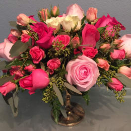 Pink and white rose bouquet in a glass vase