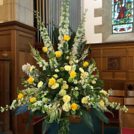 Large yellow and white floral arrangement in a church interior