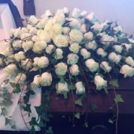 Large white rose casket spray with trailing ivy