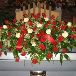 Red and white rose casket spray with ribbon