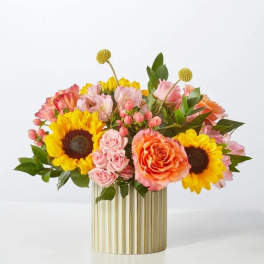 Sunflower and rose arrangement in a gold ribbed vase