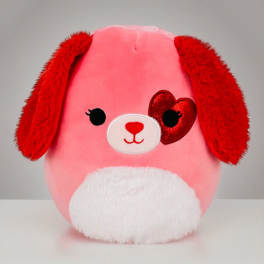 Pink and red plush puppy with floppy ears, white belly, and a red heart patch over one eye
