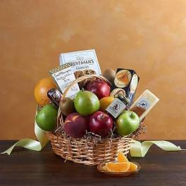 Fruit basket with apples, pears, oranges, and packaged snacks in a wicker basket