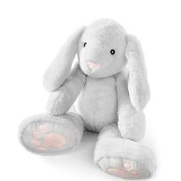 White plush bunny with pink paw pads sitting on a white background