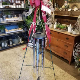 Tall memorial wind chime with a large pink ribbon bow