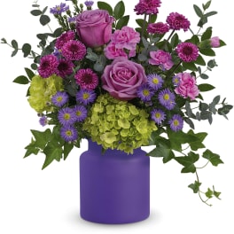 Pink and purple mixed bouquet in a purple vase