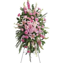 Tall pink floral standing spray on a black easel