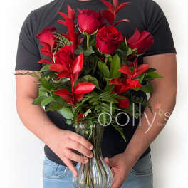 Red roses arranged in a clear glass vase