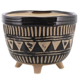 Decorative black ceramic planter with tan geometric patterns and three legs