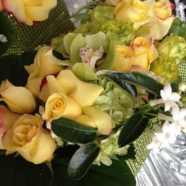 Bouquet of yellow roses with white orchids and green hydrangeas