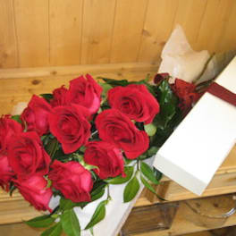 Bouquet of red roses in white wrapping with a ribbon