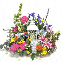 Colorful floral arrangement around a white lantern