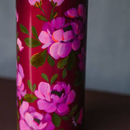 Pink floral-painted tumbler with a metal lid
