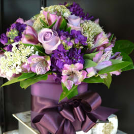 Purple and pink bouquet in a lavender box with a satin ribbon