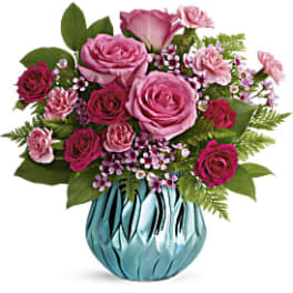 Pink roses and carnations in a blue glass vase