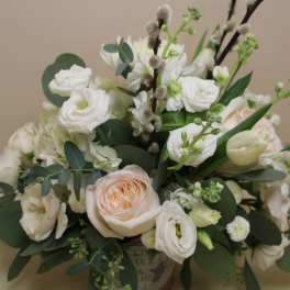 White and blush bouquet with roses and mixed blooms in a vase